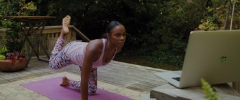 Movie still from “Sonic the Hedgehog” (2020), directed by Jeff Fowler – A woman is practicing yoga on a pink mat outside; Medium shot, High angle