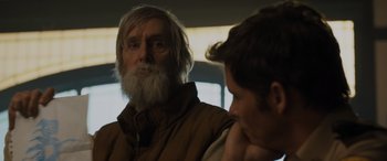 Movie still from “Sonic the Hedgehog” (2020), directed by Jeff Fowler – A man with a long white beard is looking at another man; Close Up shot, Over the shoulder angle