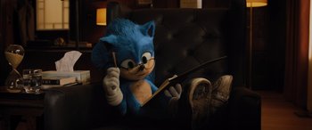 Movie still from “Sonic the Hedgehog” (2020), directed by Jeff Fowler – A stuffed animal that is sitting on a couch; Medium shot, Over the shoulder angle