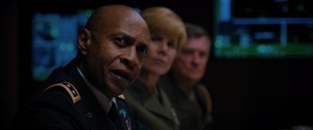 Movie still from “Sonic the Hedgehog” (2020), directed by Jeff Fowler – A man and two women are standing next to each other; Close Up shot, Low angle