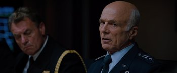 Movie still from “Sonic the Hedgehog” (2020), directed by Jeff Fowler – An older man wearing a uniform and a tie; Close Up shot, Over the shoulder angle