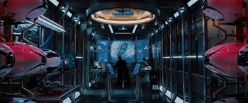 Movie still from “Sonic the Hedgehog” (2020), directed by Jeff Fowler – A man is standing in front of a screen; Extreme Wide shot, High angle