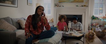 Movie still from “Sonic the Hedgehog” (2020), directed by Jeff Fowler – A woman talking on a cell phone while sitting on the floor; Medium shot, Low angle