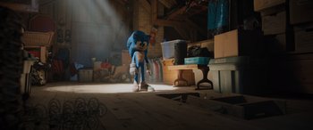 Movie still from “Sonic the Hedgehog” (2020), directed by Jeff Fowler – A toy character is standing in a room; Wide shot, Over the shoulder angle