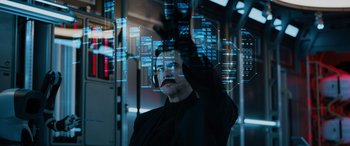 Movie still from “Sonic the Hedgehog” (2020), directed by Jeff Fowler – A man in a black jacket is looking at a computer screen; Medium shot, Low angle