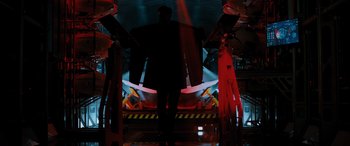 Movie still from “Sonic the Hedgehog” (2020), directed by Jeff Fowler – A man in a suit standing in front of an airplane; Wide shot, Low angle