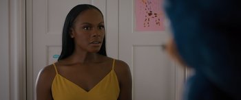 Movie still from “Sonic the Hedgehog” (2020), directed by Jeff Fowler – A woman in a yellow top looking at a mirror; Close Up shot, Over the shoulder angle