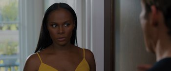 Movie still from “Sonic the Hedgehog” (2020), directed by Jeff Fowler – A woman in a yellow top looking at the camera; Close Up shot, Over the shoulder angle