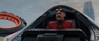 Movie still from “Sonic the Hedgehog” (2020), directed by Jeff Fowler – A man wearing goggles and a red jacket sitting in the cockpit of an airplane; Close Up shot, Over the shoulder angle