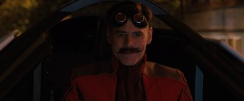 Movie still from “Sonic the Hedgehog” (2020), directed by Jeff Fowler – A man wearing goggles and a red jacket; Close Up shot, Over the shoulder angle