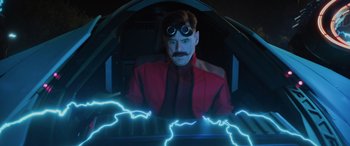 Movie still from “Sonic the Hedgehog” (2020), directed by Jeff Fowler – A man in a red jacket with goggles and a mustache; Medium shot, High angle