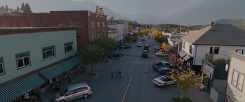 Movie still from “Sonic the Hedgehog” (2020), directed by Jeff Fowler – An aerial view of a street with cars parked on the side of the road; Extreme Wide shot, High angle
