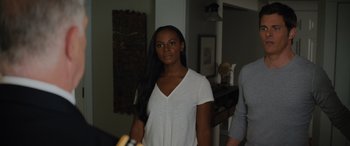 Movie still from “Sonic the Hedgehog” (2020), directed by Jeff Fowler – A woman standing in front of a mirror in a room; Medium shot, Over the shoulder angle