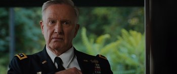 Movie still from “Sonic the Hedgehog” (2020), directed by Jeff Fowler – An older man in military uniform looking at the camera; Close Up shot, Low angle