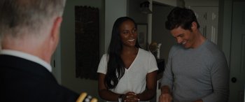 Movie still from “Sonic the Hedgehog” (2020), directed by Jeff Fowler – A woman that is standing up and smiling; Medium shot, Over the shoulder angle