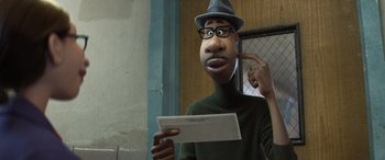 Movie still from “Soul” (2020), directed by Kemp Powers – An animated man in a hat holding a piece of paper in front of his face; Close Up shot, Low angle