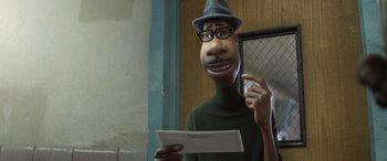 Movie still from “Soul” (2020), directed by Kemp Powers – A man in a hat is talking on the phone; Close Up shot, Over the shoulder angle