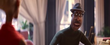 Movie still from “Soul” (2020), directed by Kemp Powers – An animated man with a hat and glasses on; Close Up shot, Over the shoulder angle