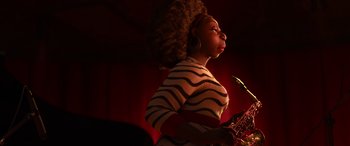 Movie still from “Soul” (2020), directed by Kemp Powers – A woman in a striped shirt is playing a saxophone; Close Up shot, Low angle