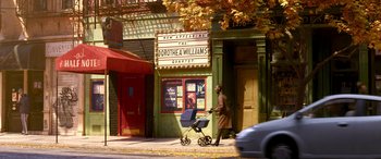 Movie still from “Soul” (2020), directed by Kemp Powers – A woman walking down the street with a baby carriage; Wide shot, Over the shoulder angle