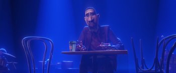 Movie still from “Soul” (2020), directed by Kemp Powers – An animated man sitting at a table with a cup of coffee in front of him; Medium shot, Over the shoulder angle