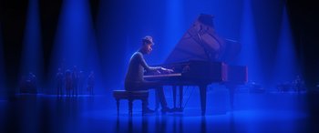 Movie still from “Soul” (2020), directed by Kemp Powers – A man sitting at a grand piano on a stage; Wide shot, Low angle