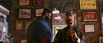 Movie still from “Soul” (2020), directed by Kemp Powers – A man with a goatee and a beard standing next to another man with a goatee; Close Up shot, Over the shoulder angle