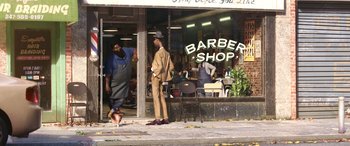 Movie still from “Soul” (2020), directed by Kemp Powers – A barber shop with two men standing outside of it; Extreme Wide shot, Low angle