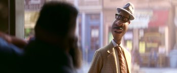 Movie still from “Soul” (2020), directed by Kemp Powers – A man in a suit and tie talking to another man; Close Up shot, Over the shoulder angle