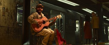 Movie still from “Soul” (2020), directed by Kemp Powers – A man sitting on a chair playing a guitar; Wide shot, Low angle