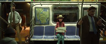 Movie still from “Soul” (2020), directed by Kemp Powers – A woman sitting on a train holding a newspaper; Wide shot, High angle