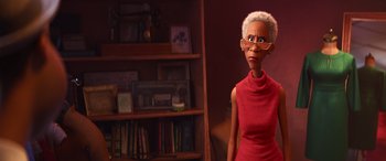 Movie still from “Soul” (2020), directed by Kemp Powers – An older woman in a red dress standing in front of a bookshelf; Medium shot, Over the shoulder angle