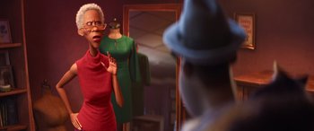 Movie still from “Soul” (2020), directed by Kemp Powers – A woman in a red dress is standing in front of a man in a hat; Medium shot, Over the shoulder angle