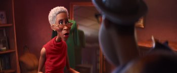 Movie still from “Soul” (2020), directed by Kemp Powers – An older woman in a red shirt is talking to a man in a green suit; Close Up shot, Over the shoulder angle