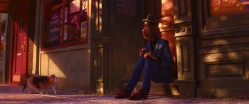 Movie still from “Soul” (2020), directed by Kemp Powers – A man sitting on the ground wearing a suit and a hat; Wide shot, Low angle