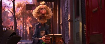 Movie still from “Soul” (2020), directed by Kemp Powers – A man with long hair and a beard is holding a drum; Medium shot, Over the shoulder angle