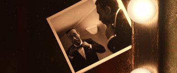 Movie still from “Soul” (2020), directed by Kemp Powers – An old photo of a man adjusting his bow tie; Extreme Close Up shot, High angle