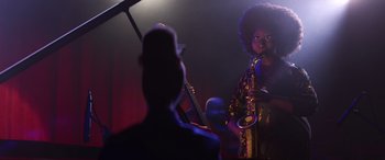 Movie still from “Soul” (2020), directed by Kemp Powers – A man playing a saxophone in front of a crowd; Medium shot, Over the shoulder angle
