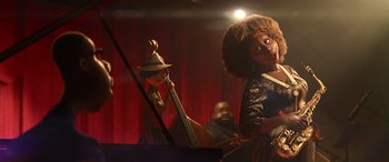 Movie still from “Soul” (2020), directed by Kemp Powers – A woman in a hat playing a contrabass and a man playing a piano in the background; Medium shot, Low angle