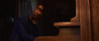Movie still from “Soul” (2020), directed by Kemp Powers – A man sitting at a table with his head resting on his hand; Close Up shot, Over the shoulder angle