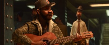 Movie still from “Soul” (2020), directed by Kemp Powers – A man with a beard and a hat is playing a guitar; Close Up shot, Over the shoulder angle