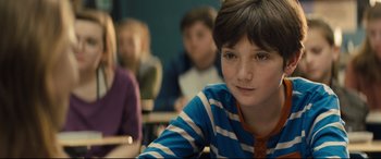 Movie still from “Brightburn” (2019), directed by David Yarovesky – A boy sitting in front of a group of other students; Close Up shot, Over the shoulder angle