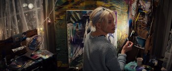 Movie still from “Brightburn” (2019), directed by David Yarovesky – A woman standing in front of a painting in front of a mirror; Medium shot, Low angle