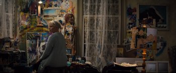 Movie still from “Brightburn” (2019), directed by David Yarovesky – A woman standing next to a window in a room; Wide shot, Over the shoulder angle