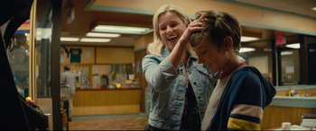 Movie still from “Brightburn” (2019), directed by David Yarovesky – A woman is fixing a boy's hair in a room; Medium shot, Over the shoulder angle