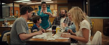 Movie still from “Brightburn” (2019), directed by David Yarovesky – A group of people sitting at a table with food; Medium shot, Over the shoulder angle