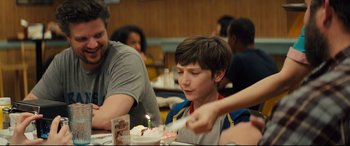 Movie still from “Brightburn” (2019), directed by David Yarovesky – A young boy blowing out a candle on a birthday cake; Close Up shot, Over the shoulder angle