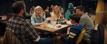 Movie still from “Brightburn” (2019), directed by David Yarovesky – A group of people sitting at a table with food on it; Medium shot, Over the shoulder angle