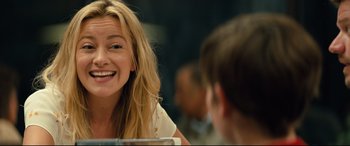 Movie still from “Brightburn” (2019), directed by David Yarovesky – A young woman smiles at a young man in front of a mirror; Close Up shot, Over the shoulder angle