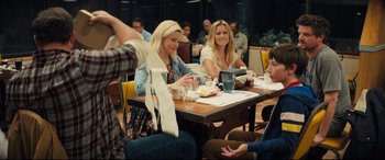 Movie still from “Brightburn” (2019), directed by David Yarovesky – A group of people sitting at a table eating food; Medium shot, Over the shoulder angle
